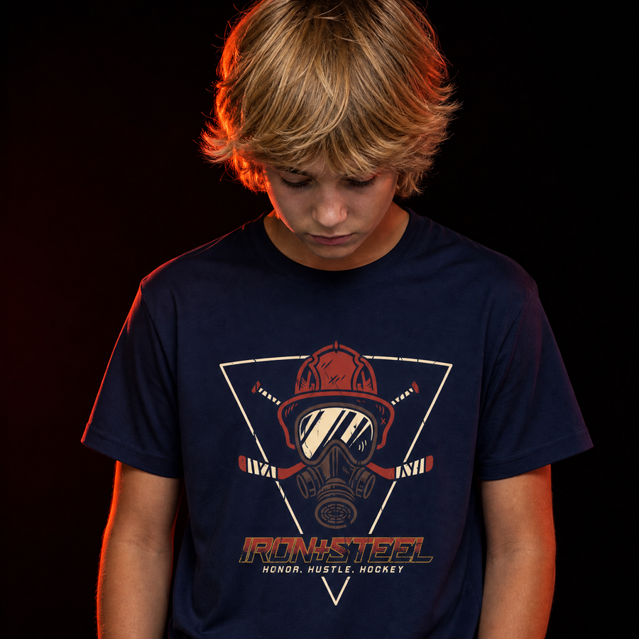 Firefighter Hustle Hockey Tee in navy worn by a young hockey player, front print with firefighter helmet, gas mask and crossed hockey sticks over the words Honor Hustle Hockey